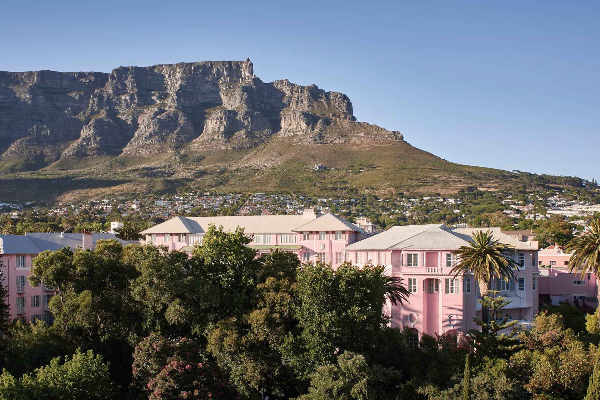 The pink-painted Belmond Mount Nelson Hotel in Cape Town is overlooked by Table Mountain