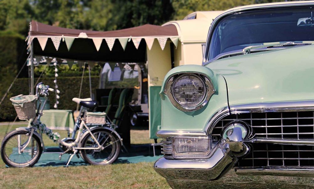 vintage car and vintage bicycle n front of tent