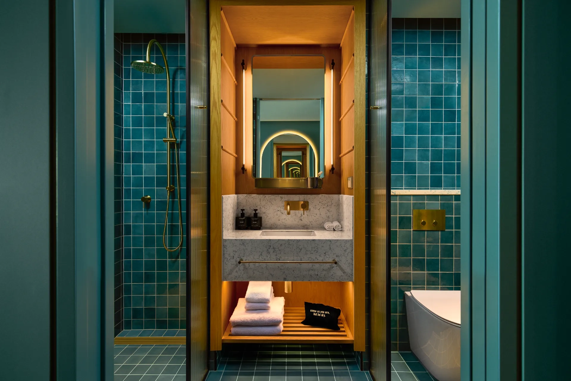 A blue-tiled bathroom in 25 Hours the Olympia hotel in Sydney